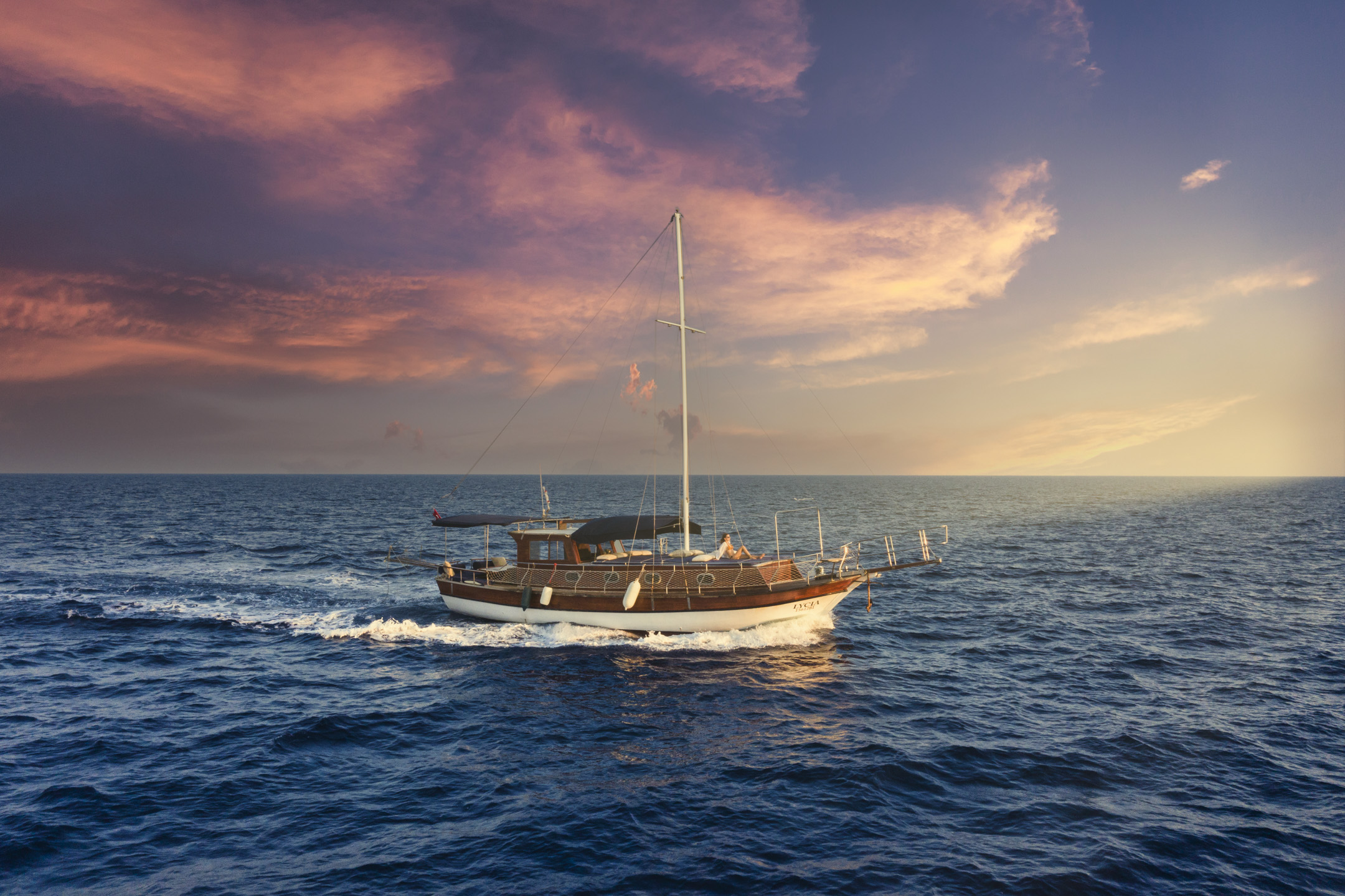 Top-down drone view of Lycia Boat anchored in deep blue water